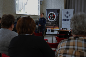 zdjęcie policjantki, na pierwszym planie uczestnicy spotkania
